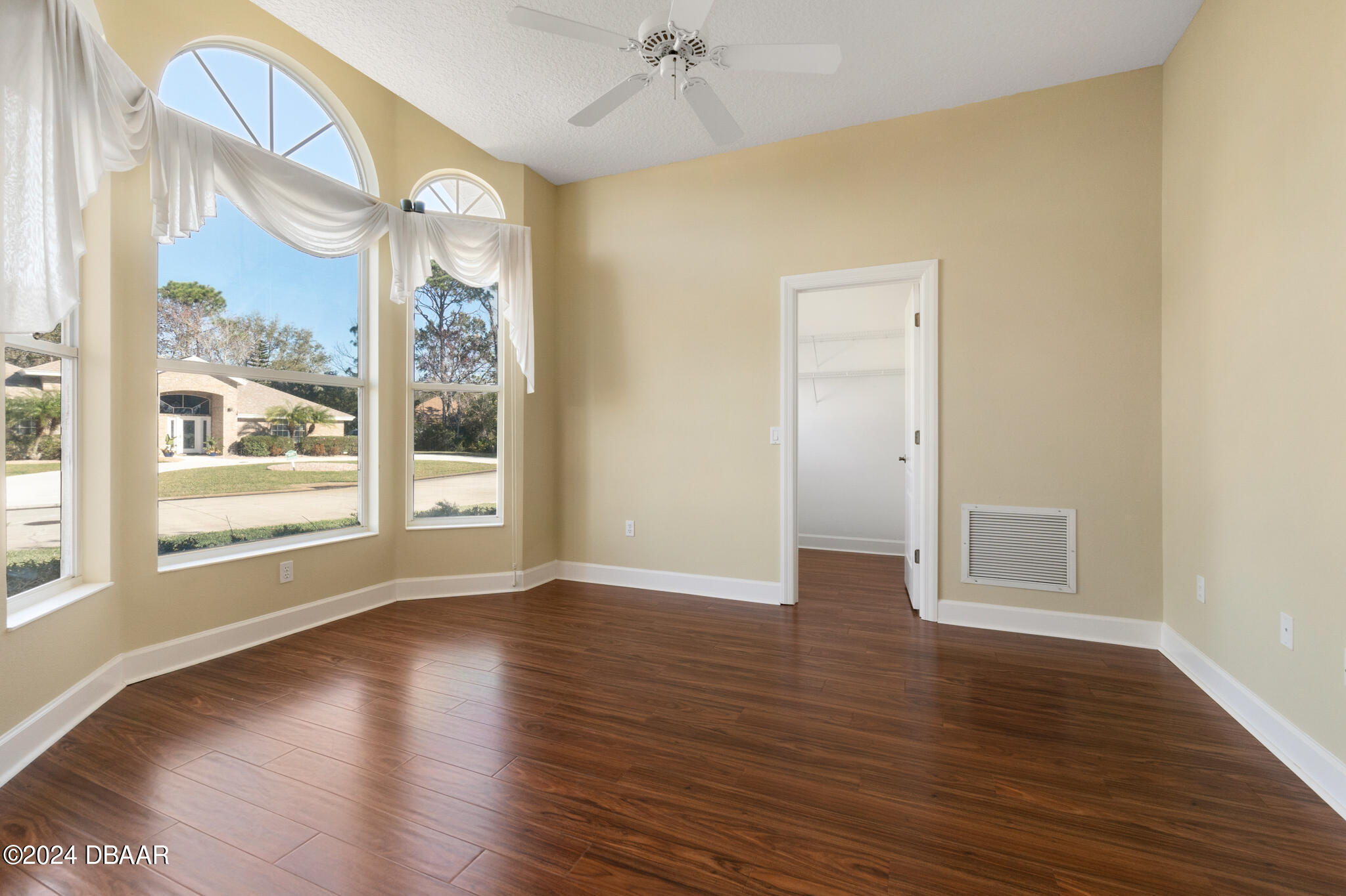710 Dolphin Head Lane Ormond Beach, FL 32174 - Photo 8 of 42 a view of an empty room with wooden floor and a window