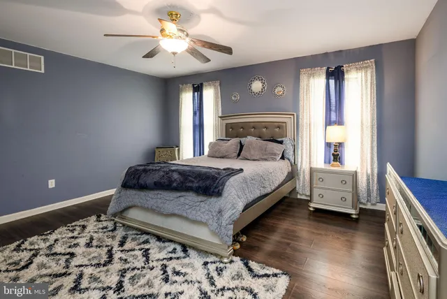 a bathroom with a tub a sink and mirror