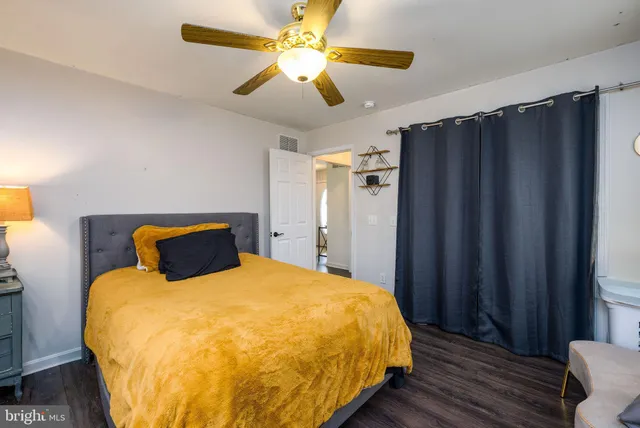 a bathroom with a sink a toilet and a shower curtain