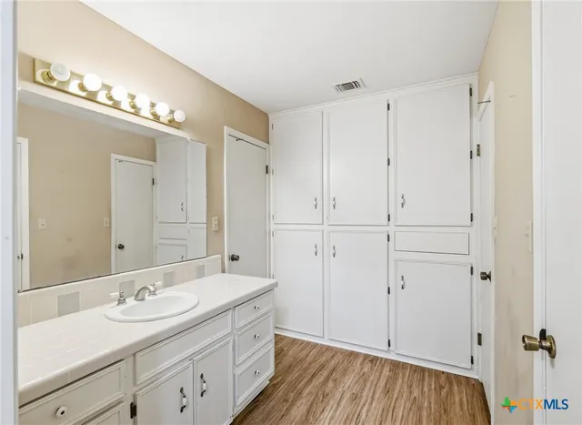 a bathroom with a double vanity sink and a mirror