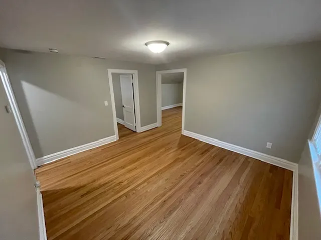 a view of room with wooden floor