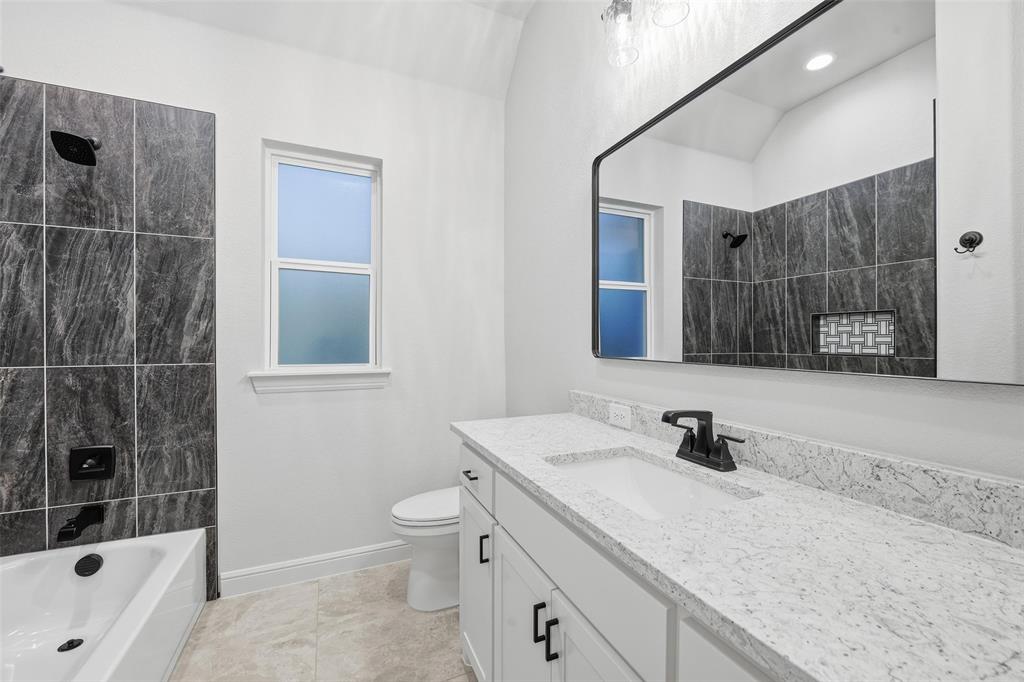 189 Rio Rancho Drive Decatur, TX 76234 - Photo 26 of 36 Bathroom with vanity, tub / shower combination, and light tile patterned floors
