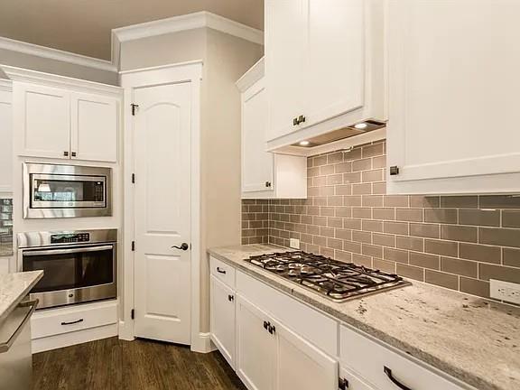 336 Kaye Street Coppell, TX 75019 - Photo 11 of 26 a kitchen with granite countertop a stove and a sink