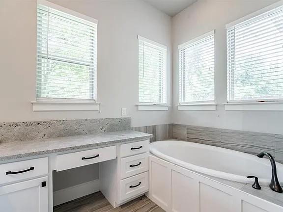 336 Kaye Street Coppell, TX 75019 - Photo 14 of 26 a bathroom with granite countertop white vanity sink and bathtub