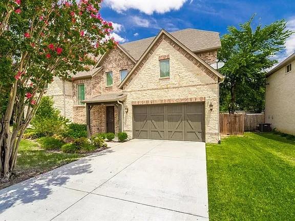 336 Kaye Street Coppell, TX 75019 - Photo 2 of 26 a front view of a house with a yard and garage