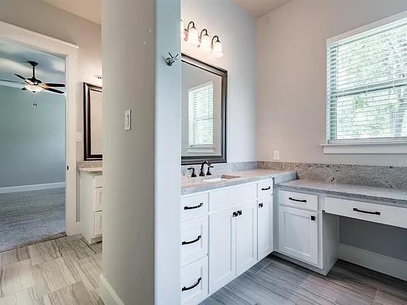 336 Kaye Street Coppell, TX 75019 - Photo 23 of 26 a bathroom with a double vanity sink a mirror and a window