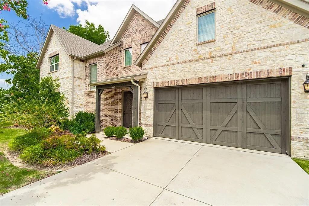 336 Kaye Street Coppell, TX 75019 - Photo 3 of 26 a front view of a house with a garage
