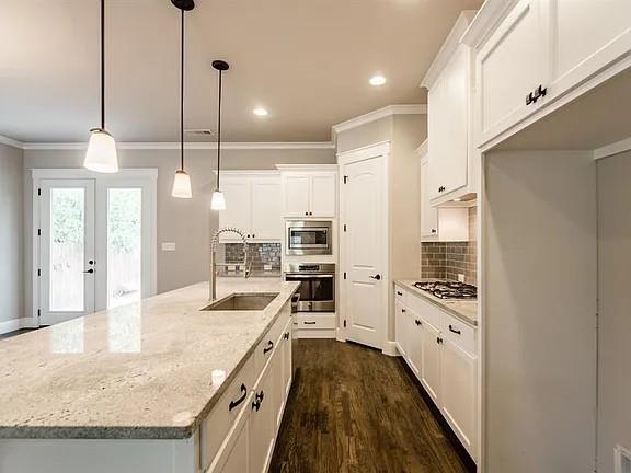 336 Kaye Street Coppell, TX 75019 - Photo 9 of 26 a kitchen with stainless steel appliances granite countertop a sink a stove and a refrigerator