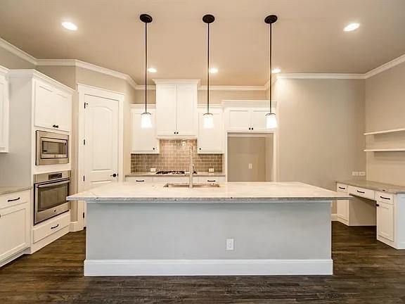 336 Kaye Street Coppell, TX 75019 - Photo 10 of 26 a kitchen with kitchen island a counter top space a sink stainless steel appliances and cabinets