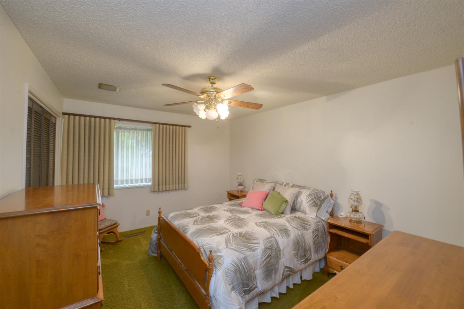 1471 Highway 33 Gustine, CA 95322 - Photo 22 of 57 a bedroom with a bed and a chandelier