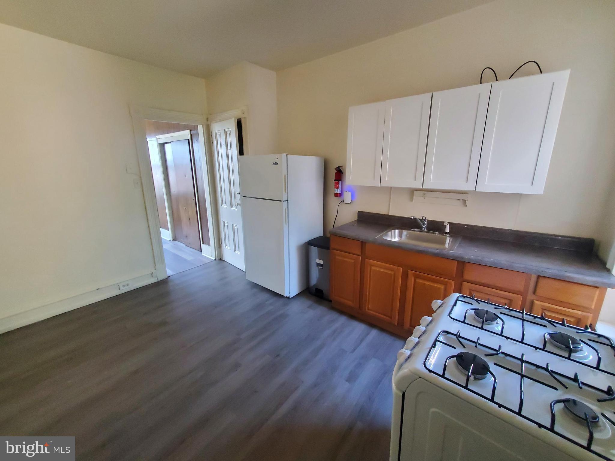 645 North 3rd Street, Unit 3 Reading, PA 19601 - Photo 3 of 10 a utility room with wooden floor and cabinets