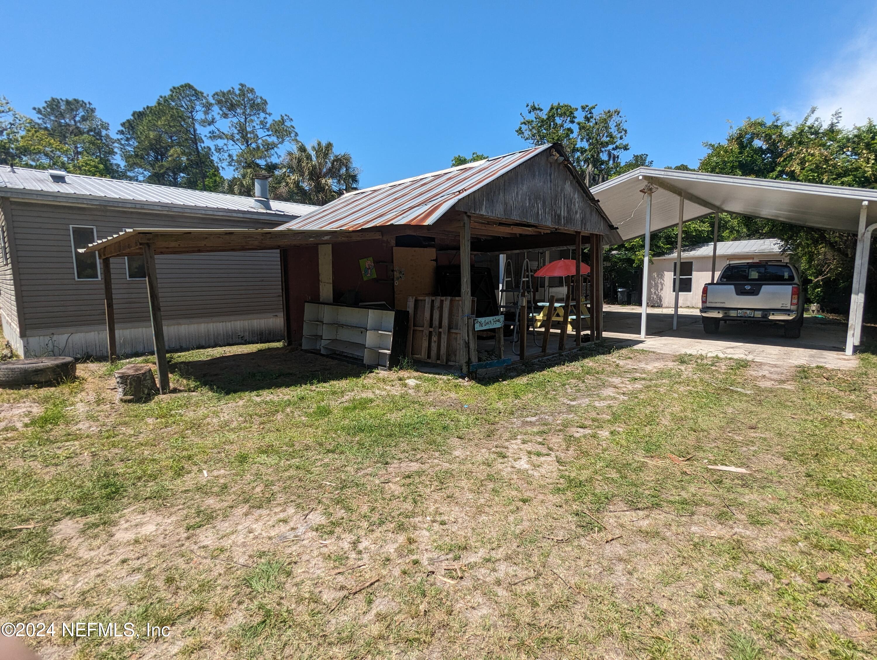 116 Islander Road Satsuma, FL 32189 - Photo 16 of 22 a view of a house with a yard and roof