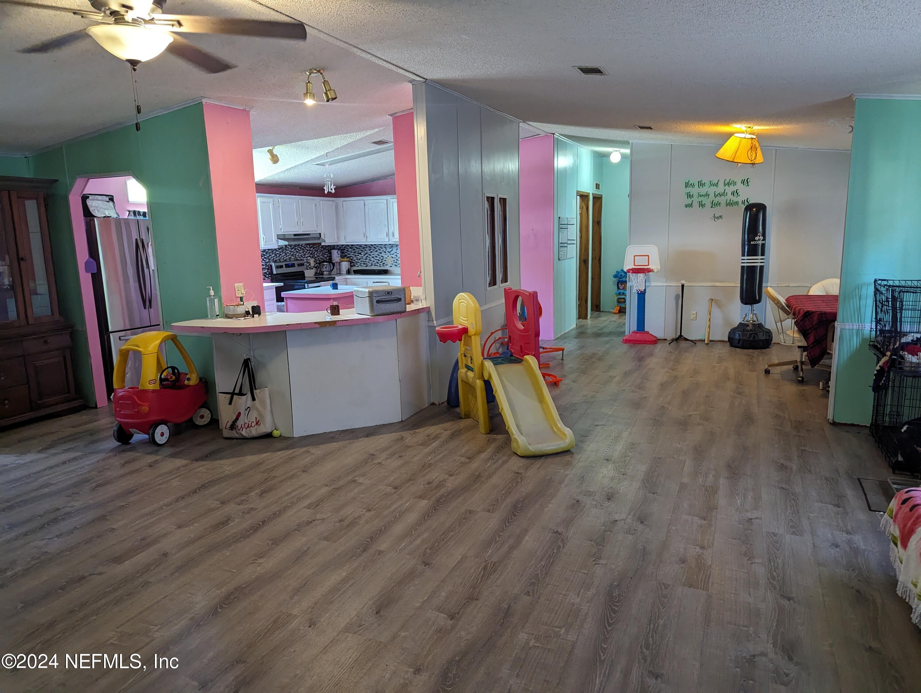 116 Islander Road Satsuma, FL 32189 - Photo 4 of 22 a view of a room with wooden floor and furniture
