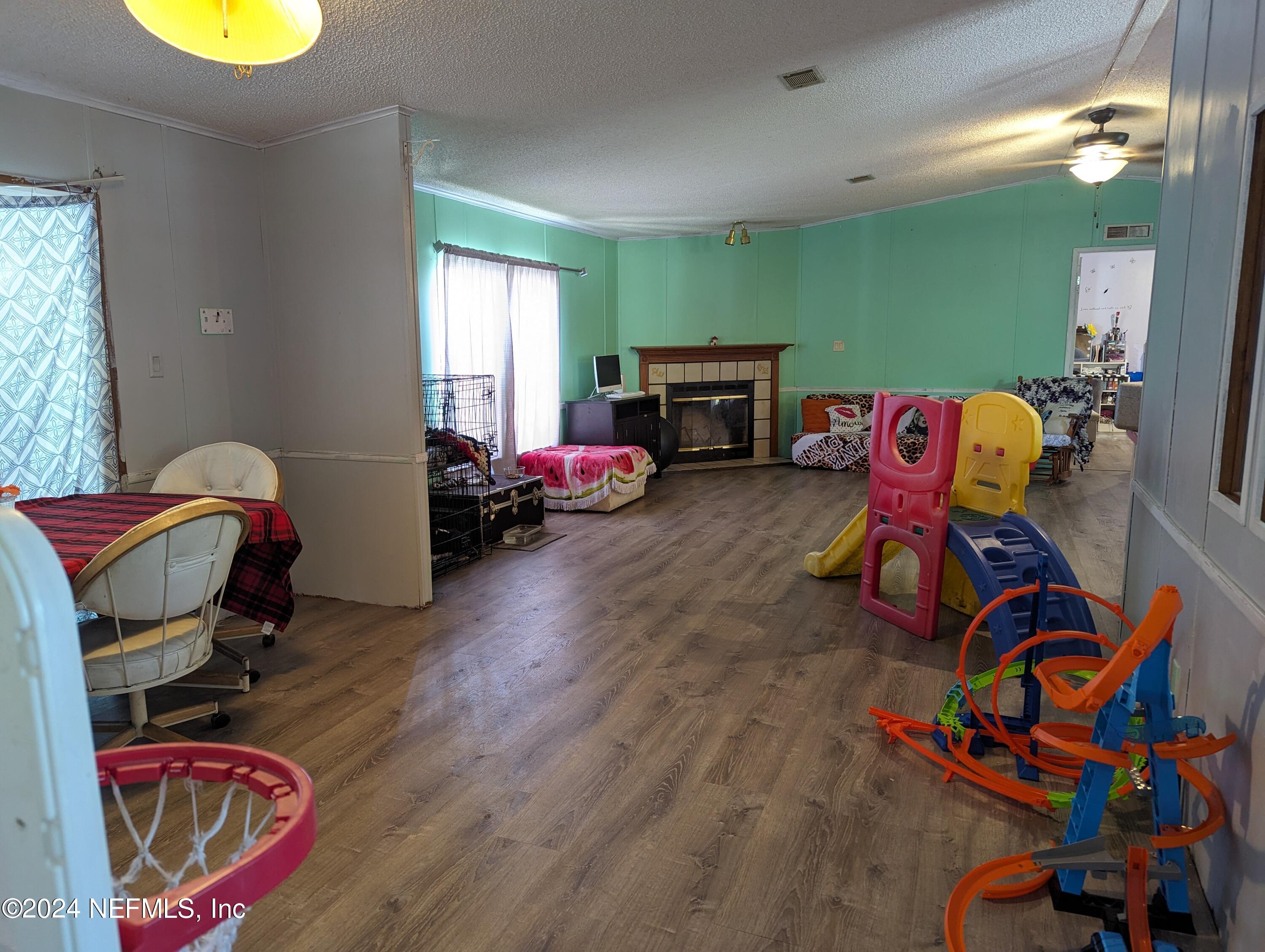 116 Islander Road Satsuma, FL 32189 - Photo 10 of 22 a bedroom with furniture and a wooden floor