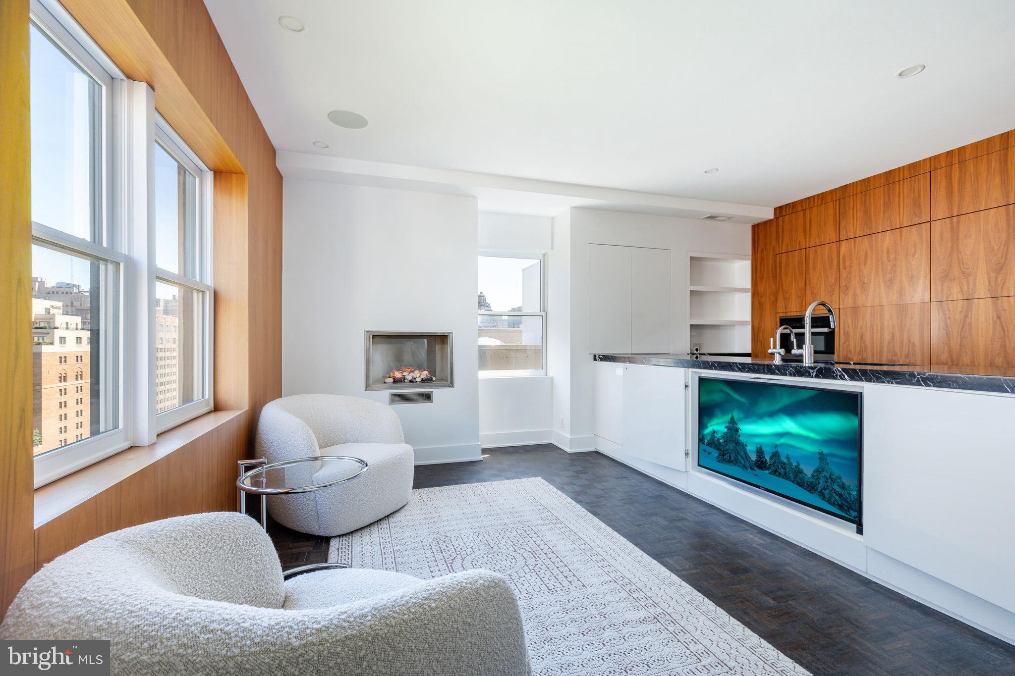 1830 Rittenhouse Square, Unit 17B Philadelphia, PA 19103 - Photo 16 of 39 a living room with furniture and a fireplace