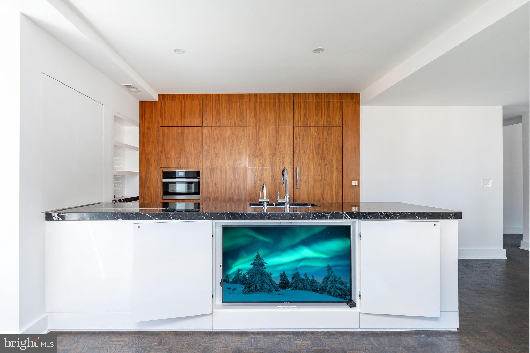 1830 Rittenhouse Square, Unit 17B Philadelphia, PA 19103 - Photo 17 of 39 a kitchen with a sink a counter top space and cabinets