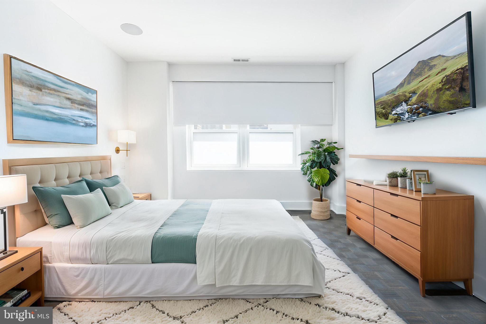 1830 Rittenhouse Square, Unit 17B Philadelphia, PA 19103 - Photo 23 of 39 a bedroom with a large bed and a chandelier