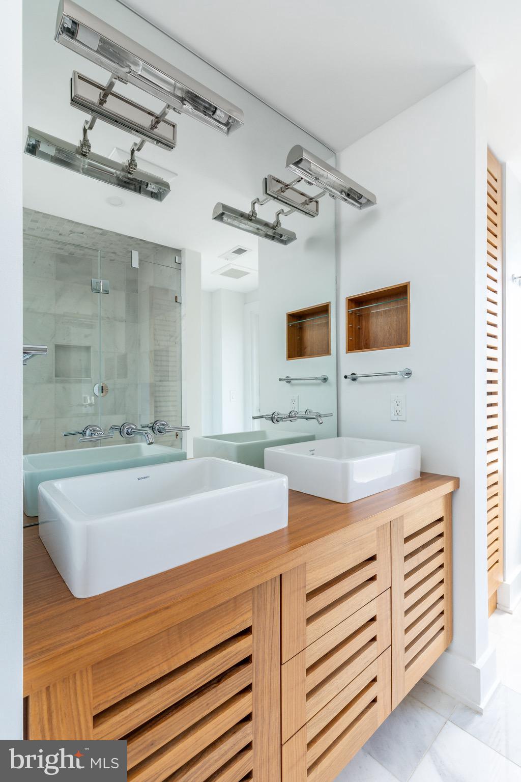 1830 Rittenhouse Square, Unit 17B Philadelphia, PA 19103 - Photo 27 of 39 a bathroom with a sink and a mirror