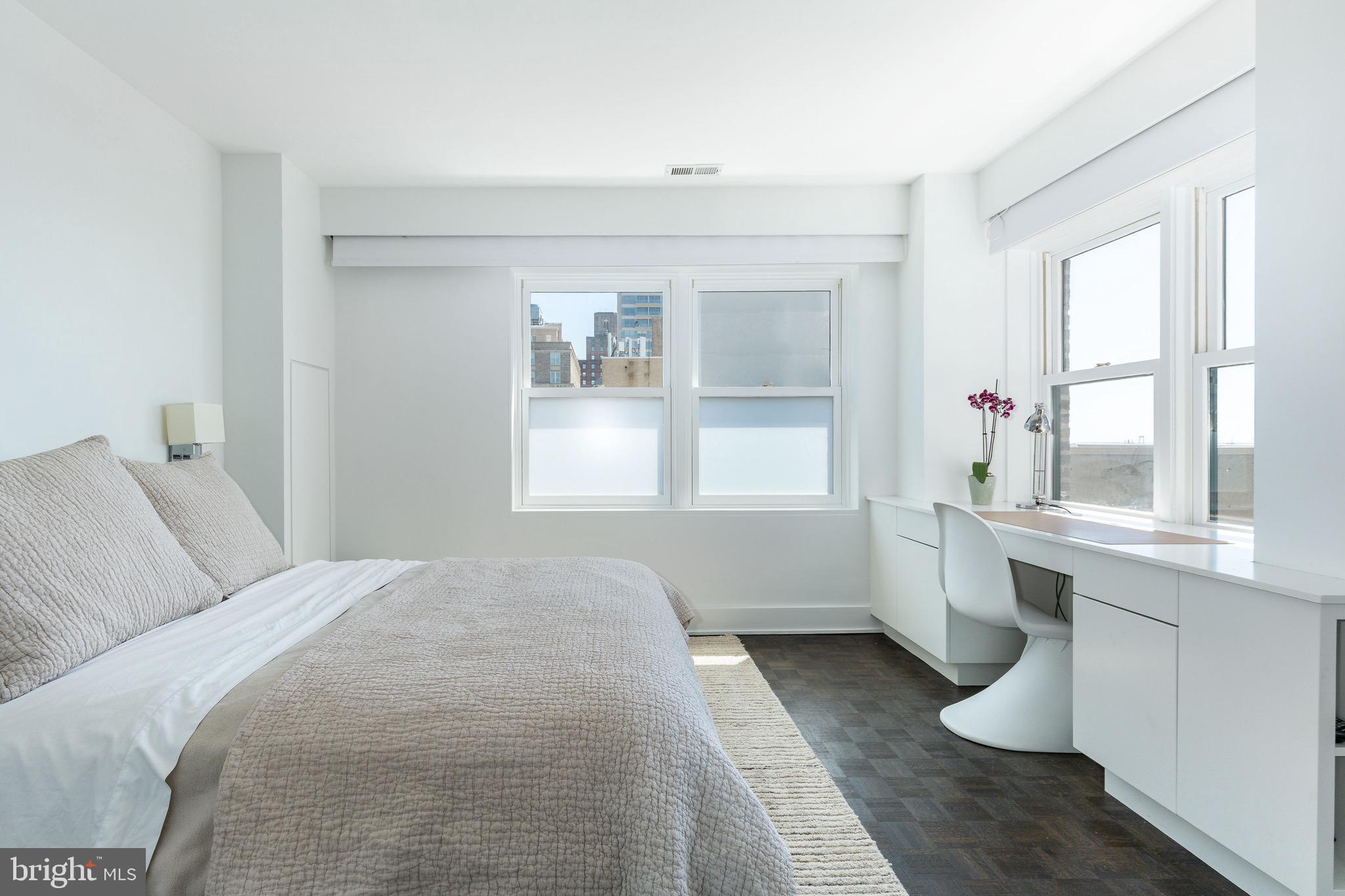 1830 Rittenhouse Square, Unit 17B Philadelphia, PA 19103 - Photo 29 of 39 a room with a white bed furniture and a window