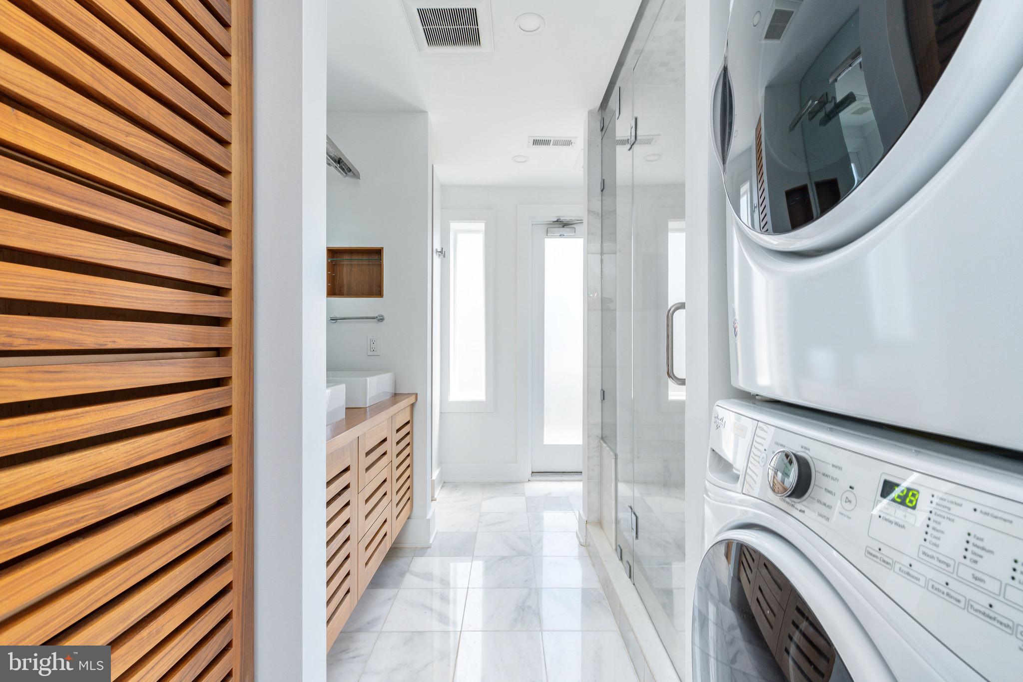 1830 Rittenhouse Square, Unit 17B Philadelphia, PA 19103 - Photo 30 of 39 a view of a hallway with washer and dryer