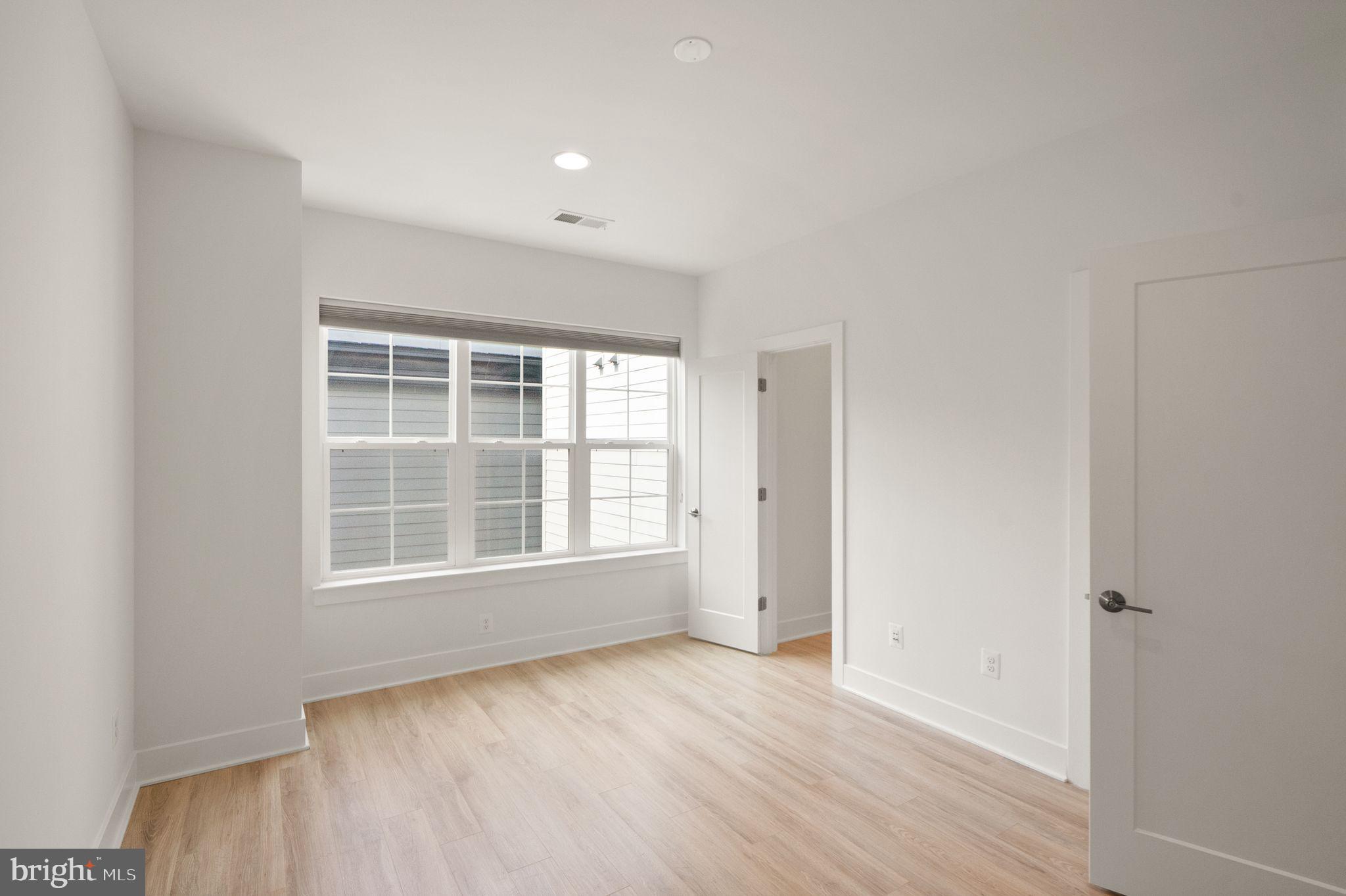 1862 Michael Faraday Drive Reston, VA 20190 - Photo 11 of 35 an empty room with wooden floor and windows