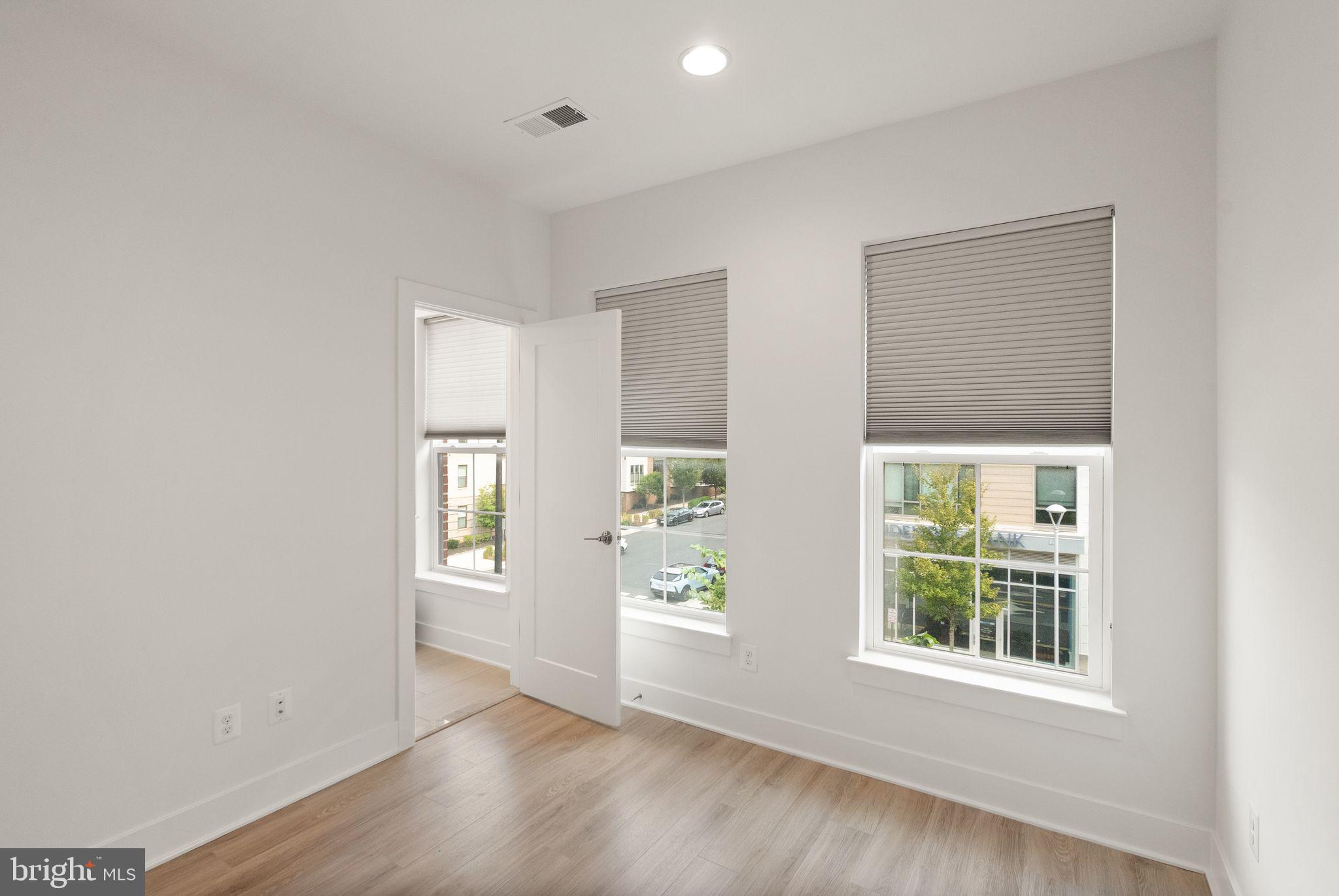 1862 Michael Faraday Drive Reston, VA 20190 - Photo 16 of 35 an empty room with windows and closet