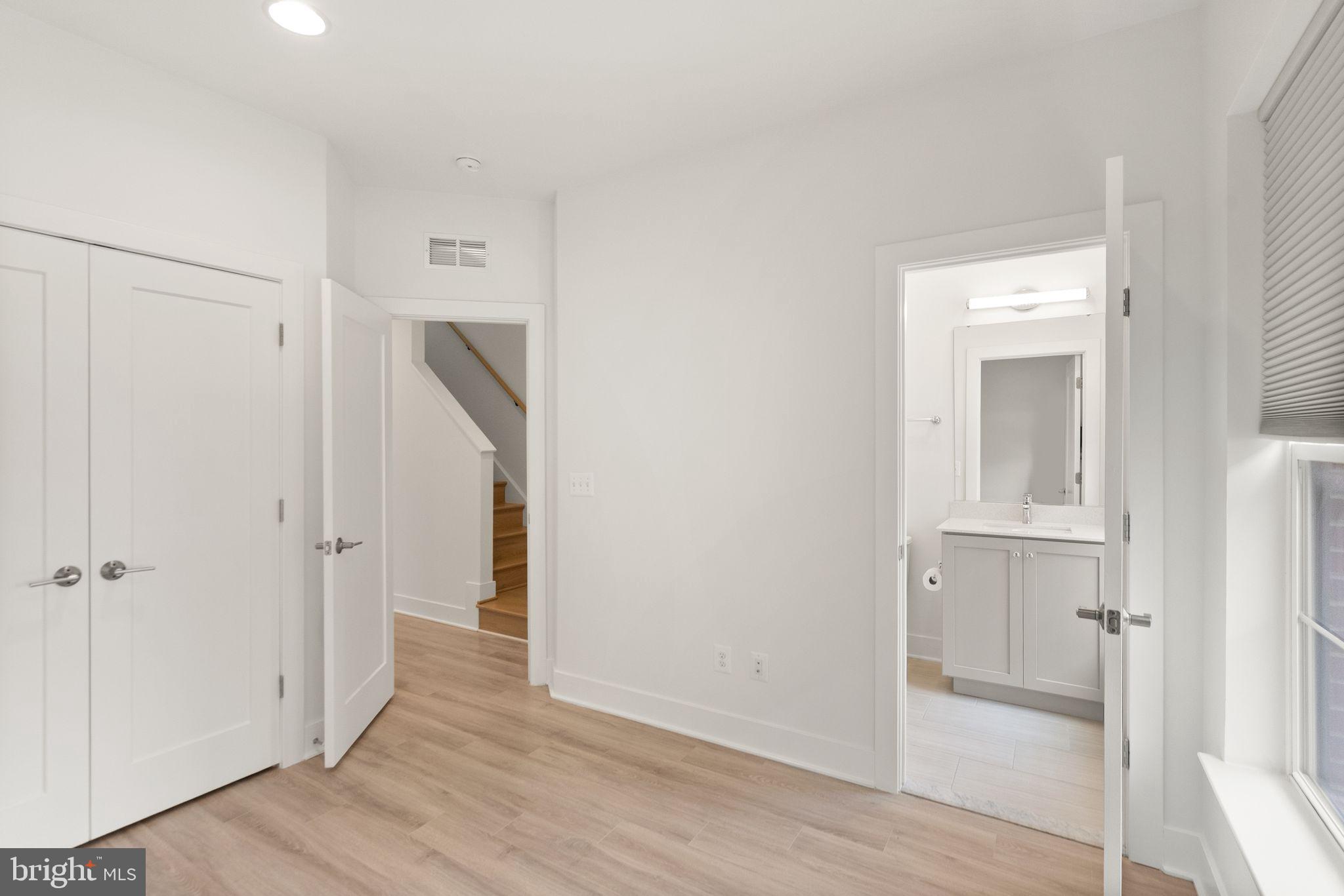 1862 Michael Faraday Drive Reston, VA 20190 - Photo 17 of 35 a view of a hallway with wooden floor and closet area