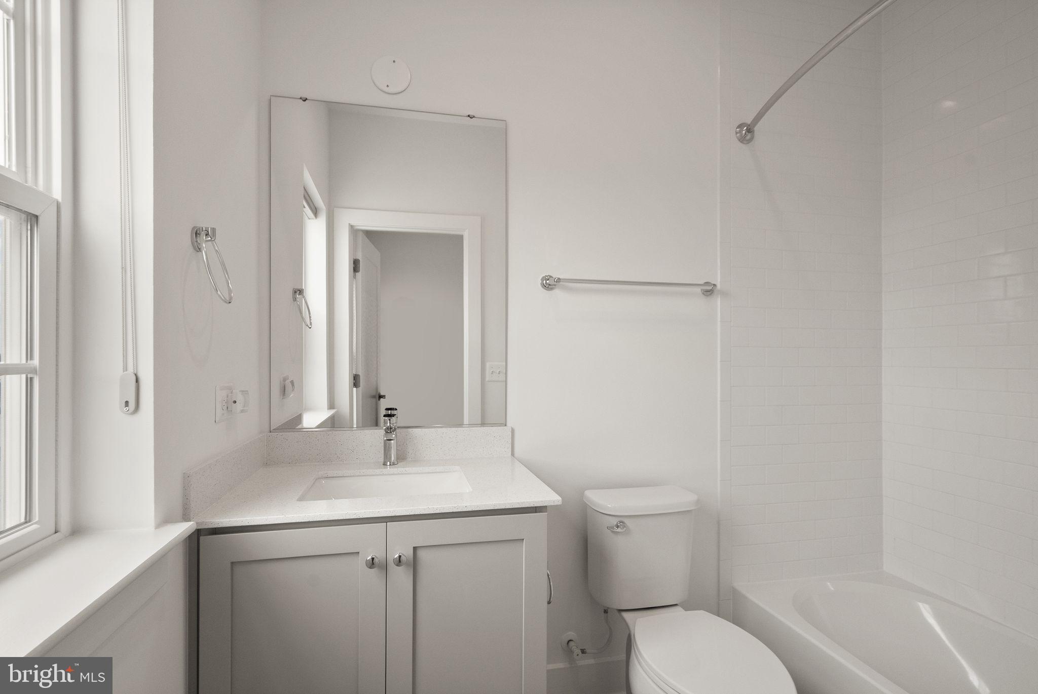 1862 Michael Faraday Drive Reston, VA 20190 - Photo 25 of 35 a bathroom with a toilet sink and mirror