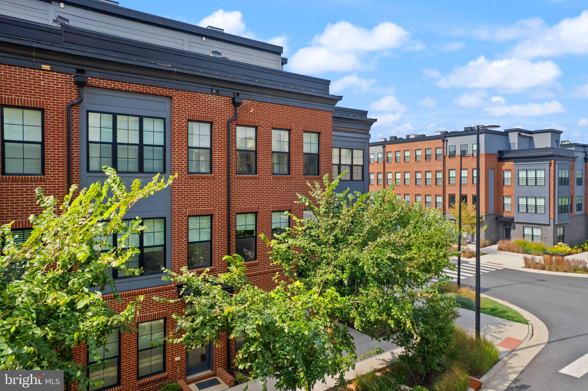 1862 Michael Faraday Drive Reston, VA 20190 - Photo 29 of 35 a front view of a residential apartment building with a yard