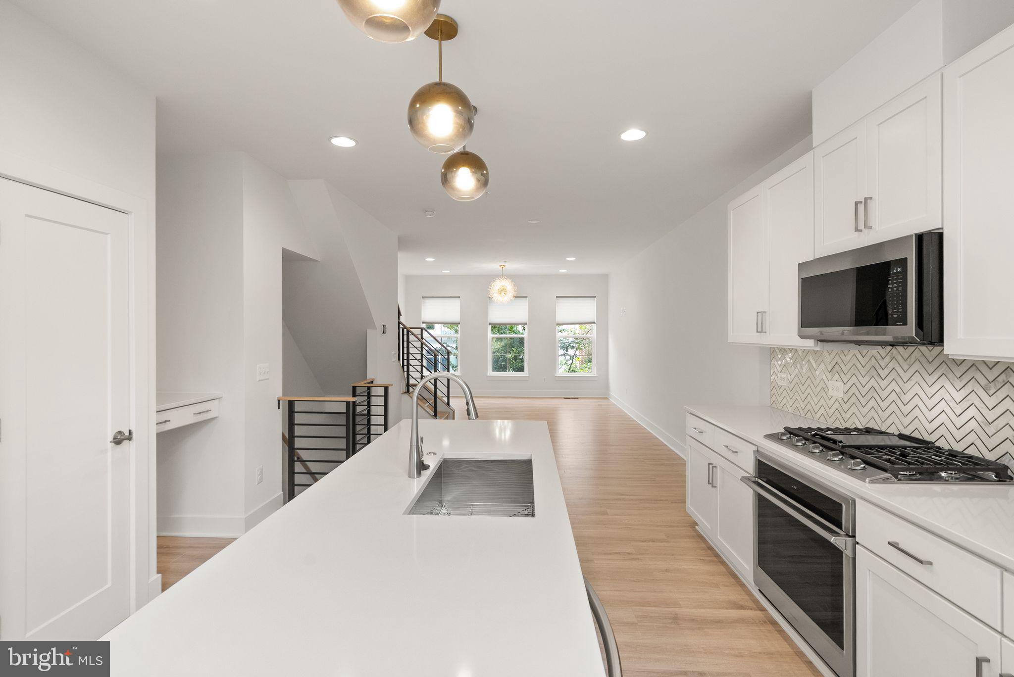 1862 Michael Faraday Drive Reston, VA 20190 - Photo 5 of 35 a large white kitchen with stainless steel appliances