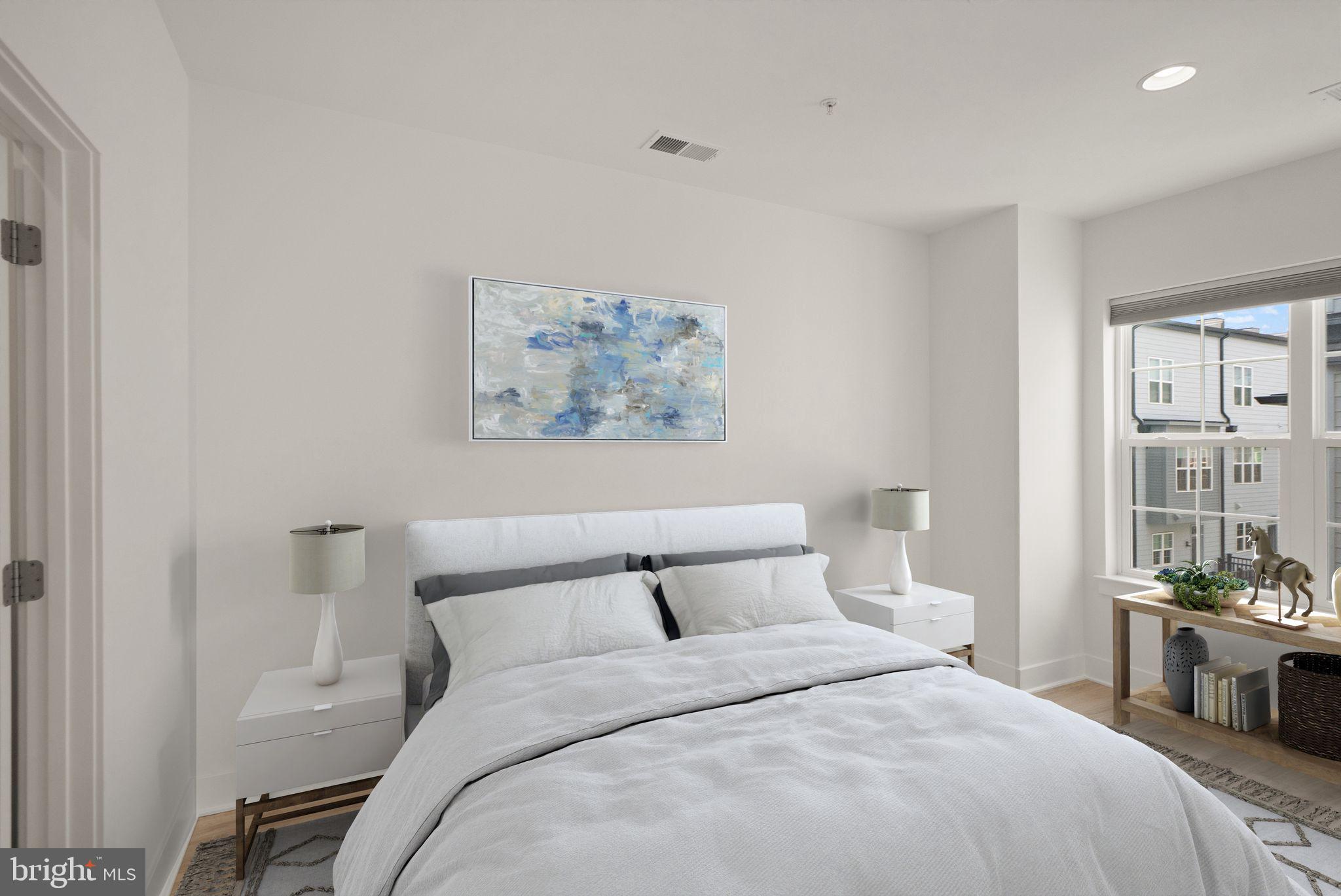 1862 Michael Faraday Drive Reston, VA 20190 - Photo 10 of 35 a bedroom with a bed and a painting on the wall