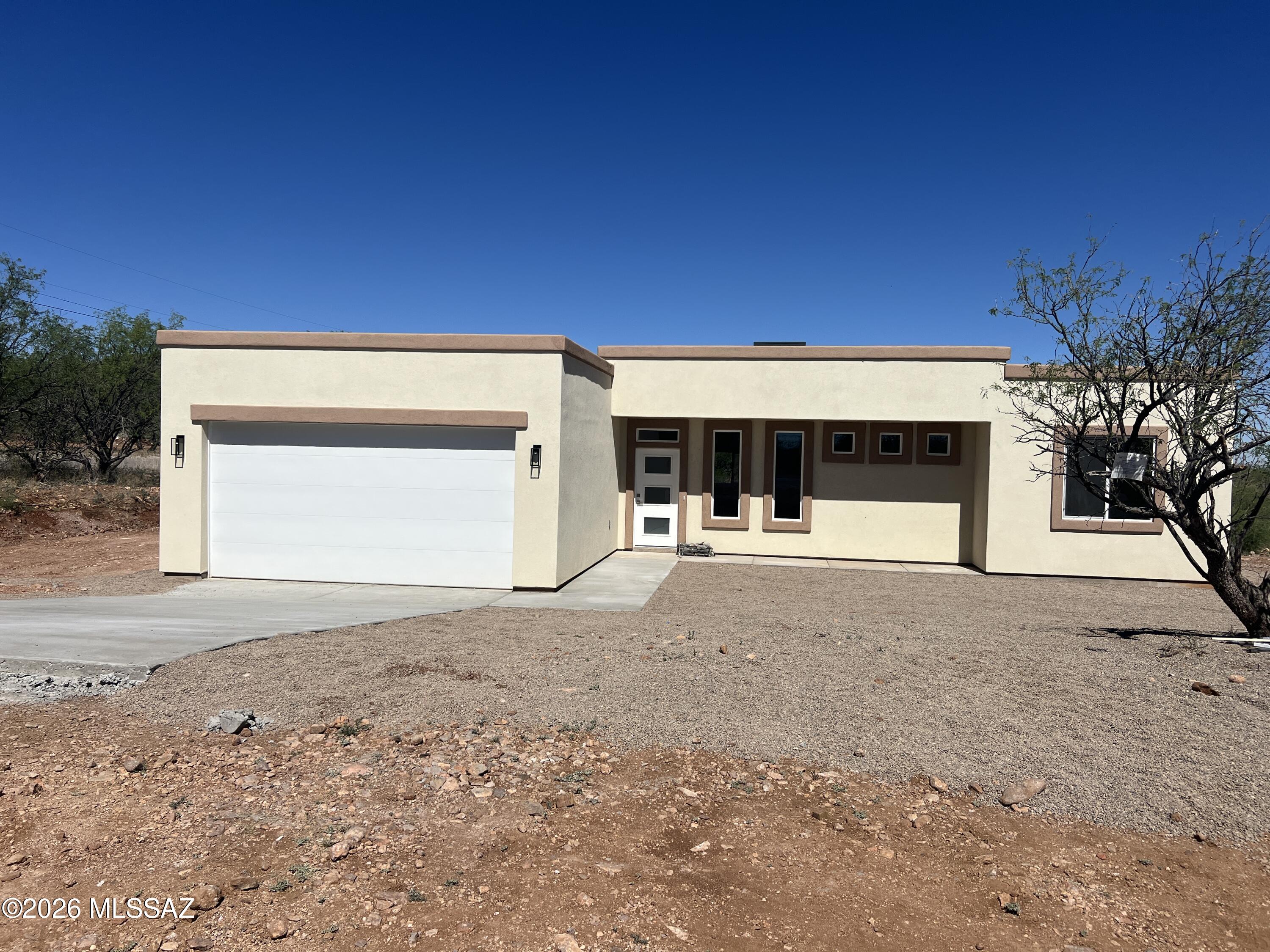 1501 Circulo Sombrero Rio Rico, AZ 85648 - Photo 1 of 26 a front view of a house with a yard and garage
