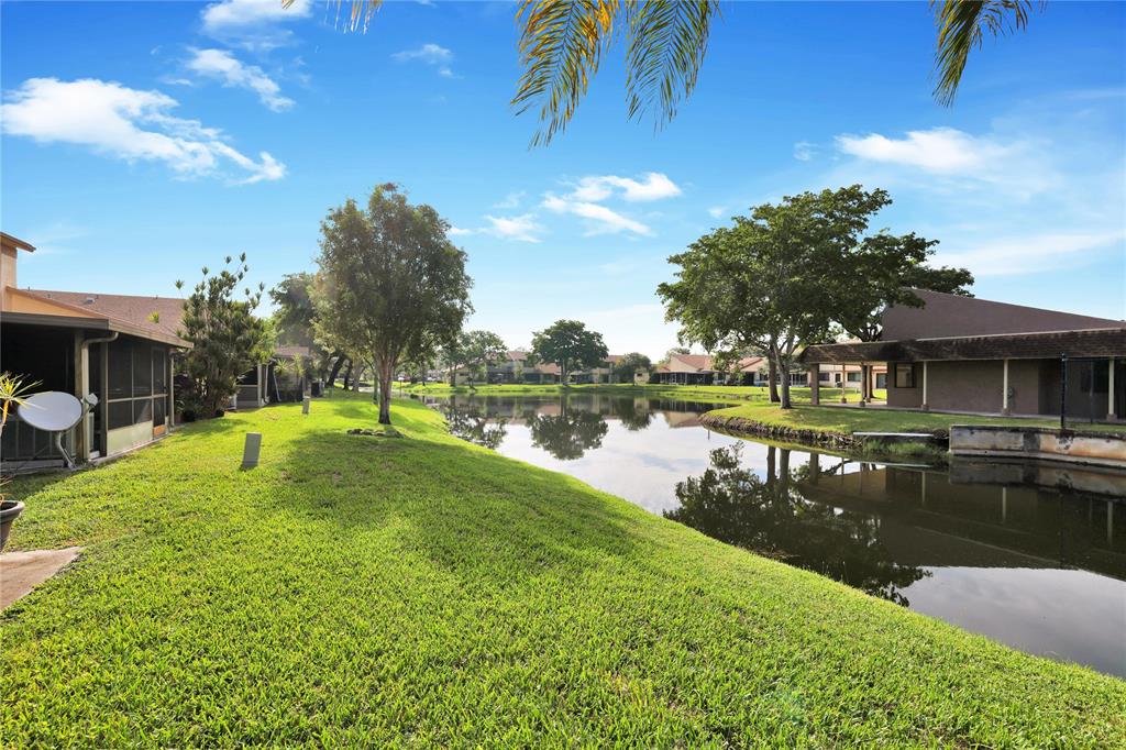 10700 Northwest 30th Place, Unit 7 Sunrise, FL 33322 - Photo 21 of 21 a view of a lake with a house in the background