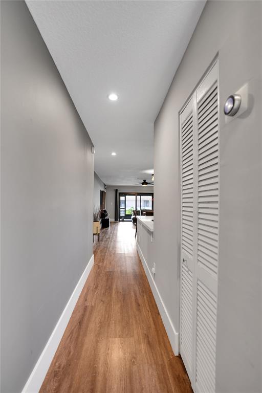 10700 Northwest 30th Place, Unit 7 Sunrise, FL 33322 - Photo 3 of 21 a view of a hallway with wooden floor and a potted plant
