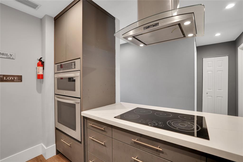 10700 Northwest 30th Place, Unit 7 Sunrise, FL 33322 - Photo 4 of 21 a kitchen with a refrigerator and cabinets