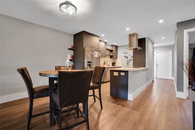 a dining room with furniture and wooden floor