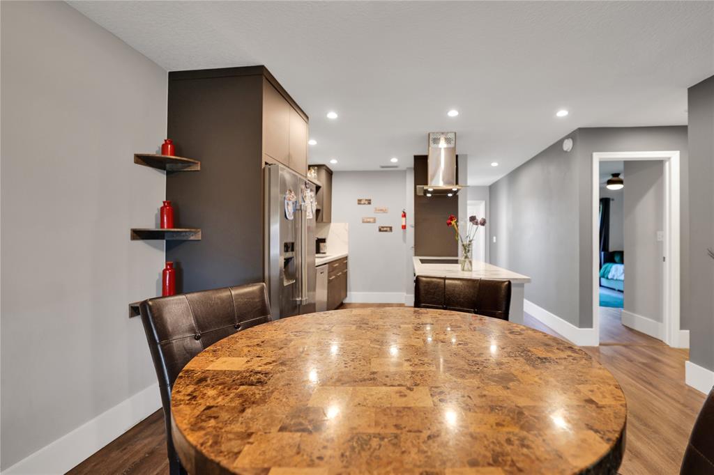 10700 Northwest 30th Place, Unit 7 Sunrise, FL 33322 - Photo 6 of 21 a kitchen with stainless steel appliances kitchen island granite countertop a sink and a refrigerator