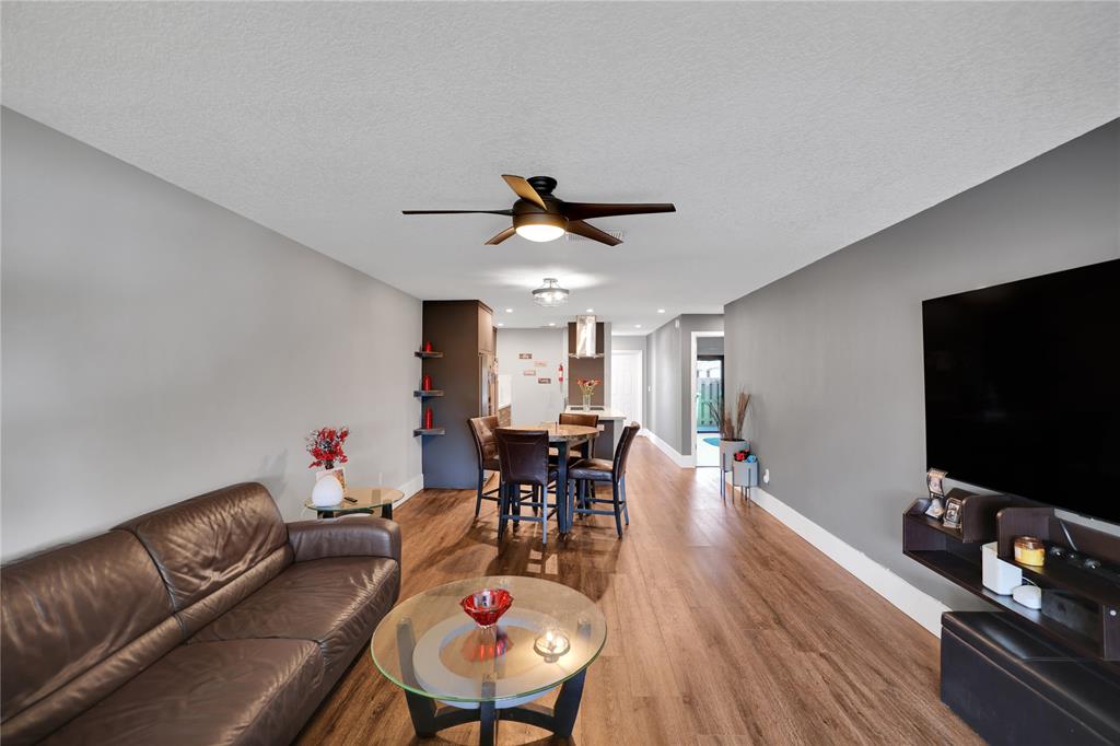 10700 Northwest 30th Place, Unit 7 Sunrise, FL 33322 - Photo 7 of 21 a living room with furniture and a flat screen tv