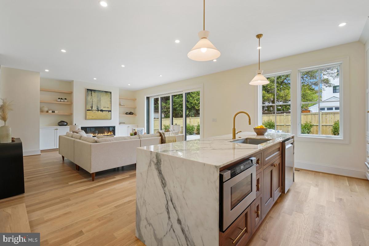 4339 Windom Place Northwest Washington, DC 20016 - Photo 13 of 45 a large kitchen with kitchen island a stove a sink a center island and windows