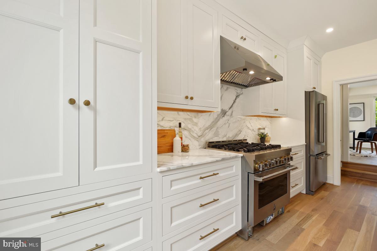 4339 Windom Place Northwest Washington, DC 20016 - Photo 15 of 45 a kitchen with stainless steel appliances white cabinets and a stove