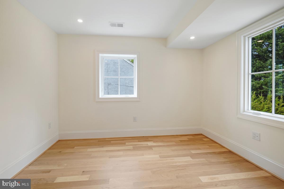 4339 Windom Place Northwest Washington, DC 20016 - Photo 26 of 45 an empty room with wooden floor and windows