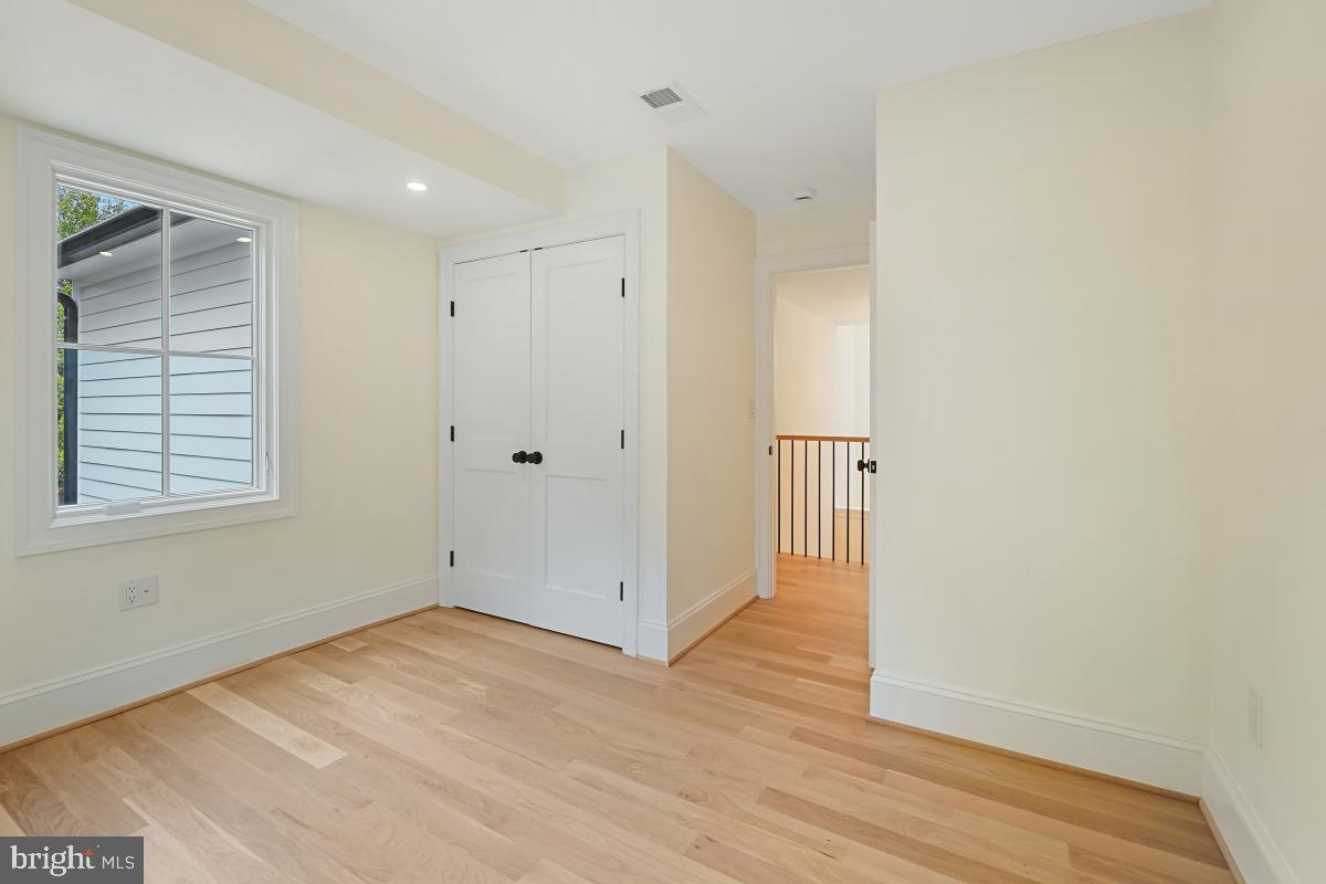 4339 Windom Place Northwest Washington, DC 20016 - Photo 27 of 45 a view of an empty room with wooden floor and a window