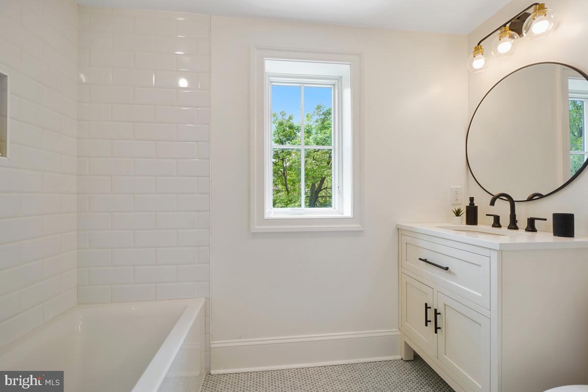 4339 Windom Place Northwest Washington, DC 20016 - Photo 29 of 45 a bathroom with a sink and a mirror