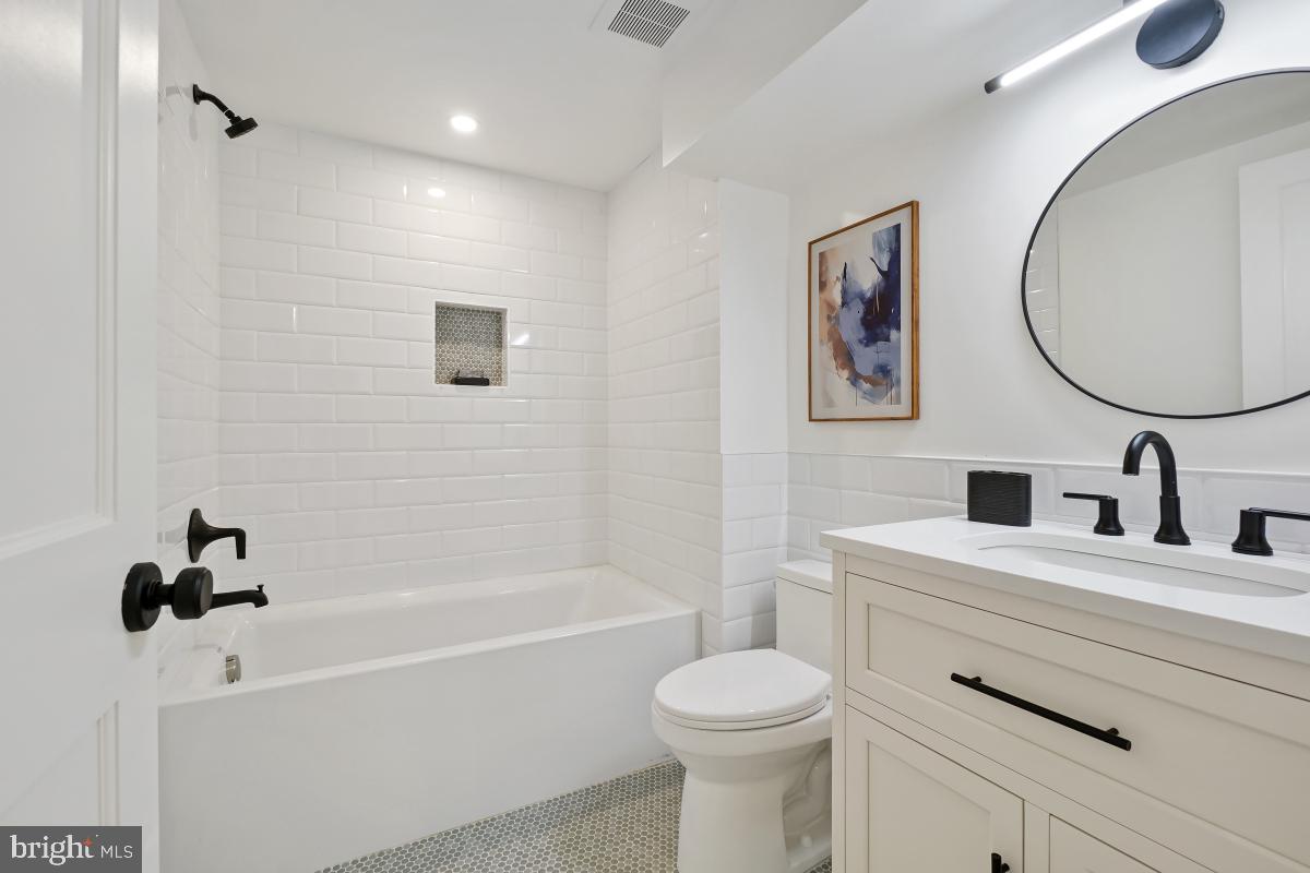 4339 Windom Place Northwest Washington, DC 20016 - Photo 42 of 45 a bathroom with a bathtub sink vanity mirror and toilet