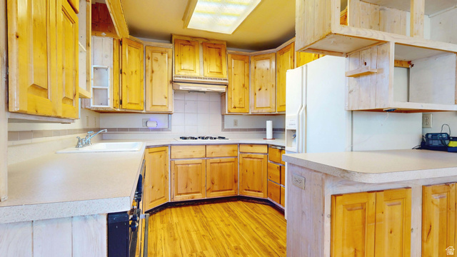 2000 Anderson Jct Road Toquerville, UT 84774 - Photo 8 of 45 Kitchen with open shelves, light countertops, decorative backsplash, light wood-type flooring, and white refrigerator with ice dispenser
