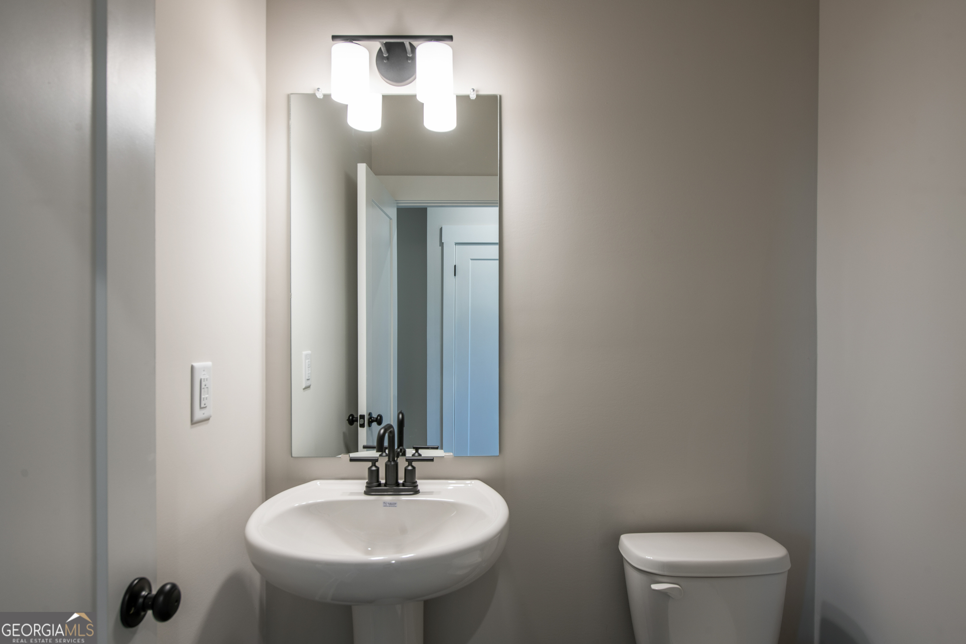 152 Henley Street, Unit 13 Canton, GA 30114 - Photo 11 of 37 a bathroom with a toilet a sink and mirror