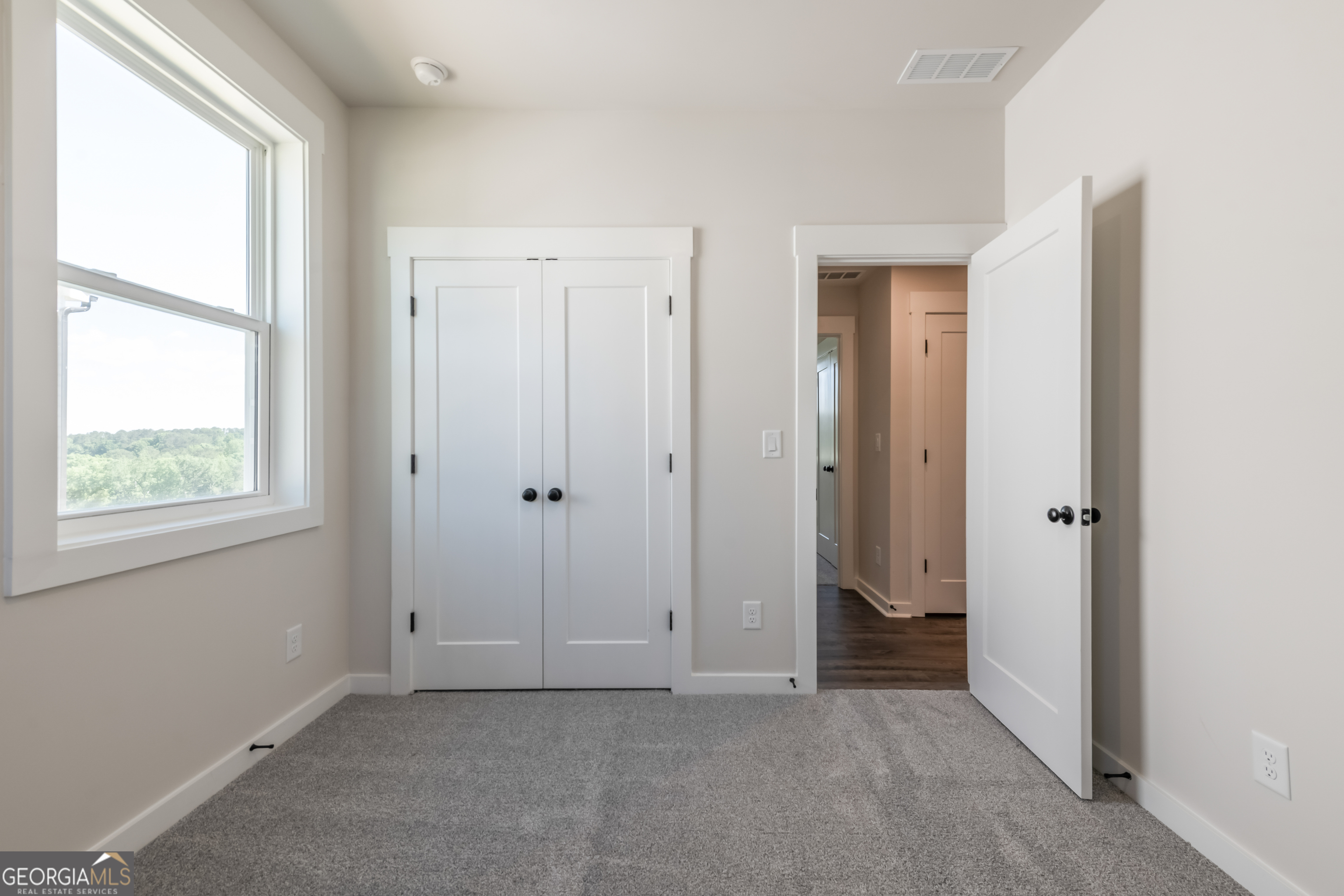 152 Henley Street, Unit 13 Canton, GA 30114 - Photo 12 of 37 an empty room with windows and closet