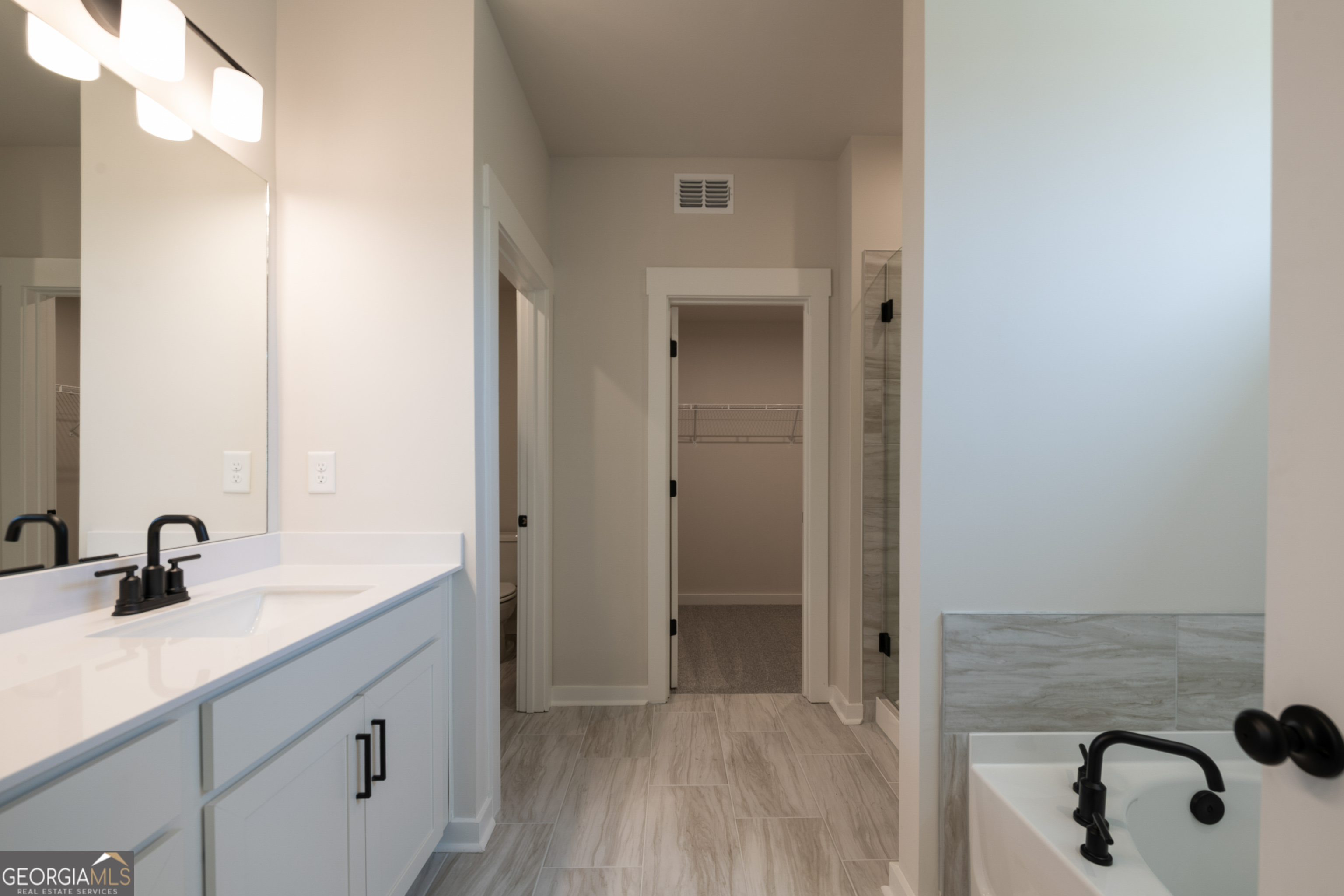 152 Henley Street, Unit 13 Canton, GA 30114 - Photo 18 of 37 a bathroom with a sink and a mirror