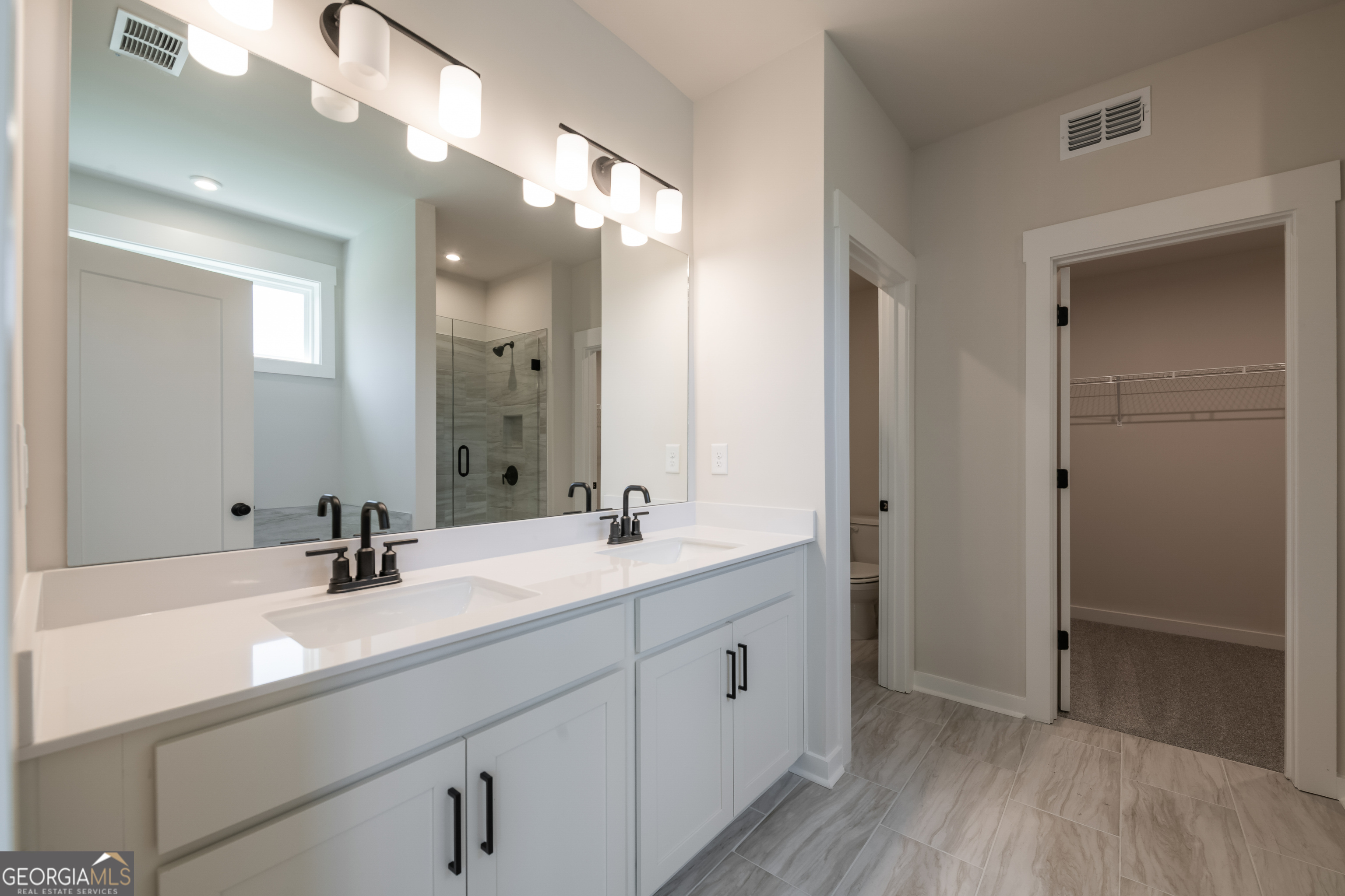 152 Henley Street, Unit 13 Canton, GA 30114 - Photo 19 of 37 a bathroom with a double vanity sink mirror and shower