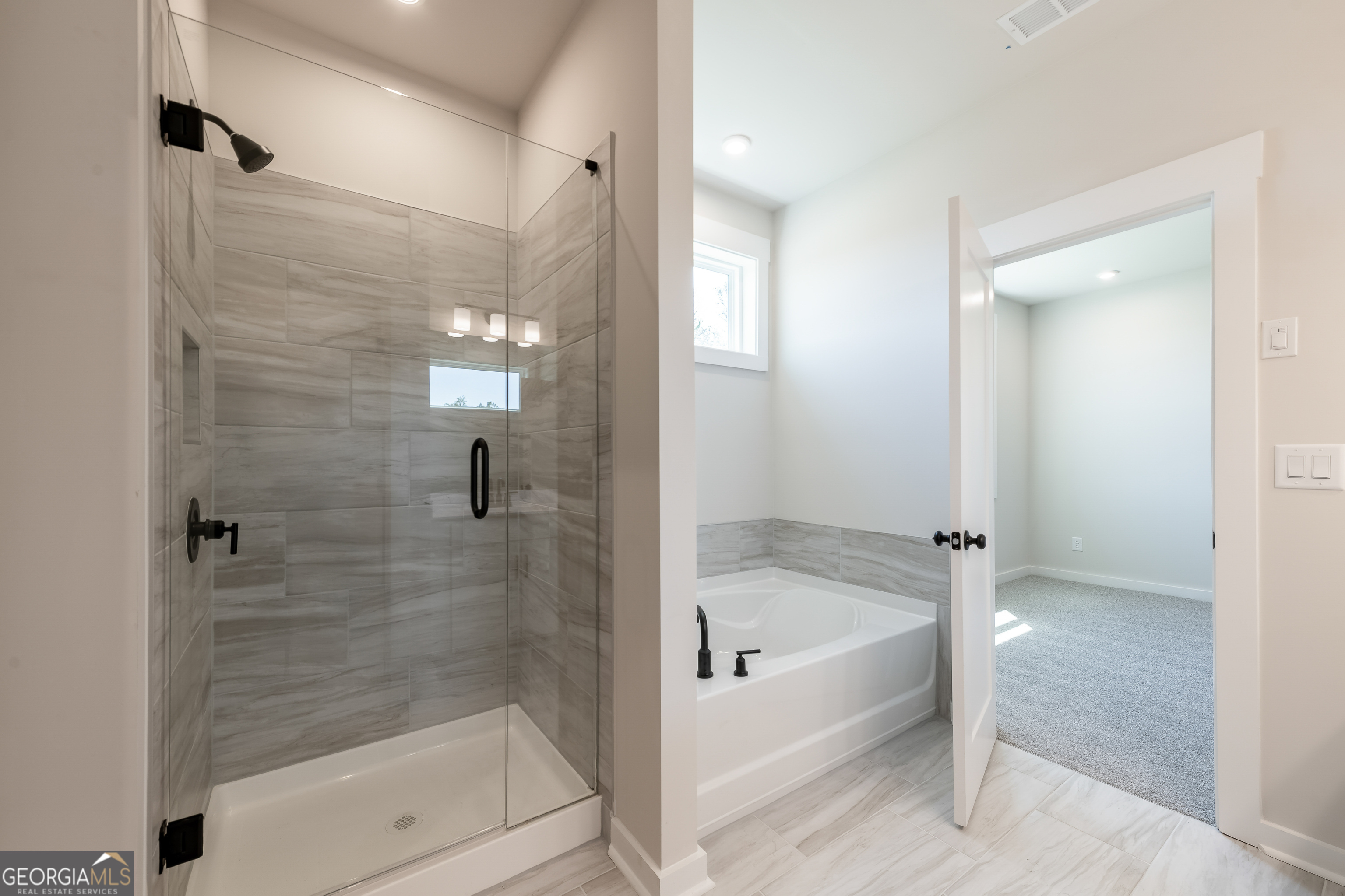152 Henley Street, Unit 13 Canton, GA 30114 - Photo 21 of 37 a bathroom with a bathtub and shower